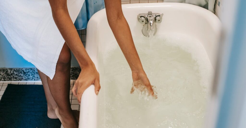 Ethnic woman pouring water into bath for morning routine